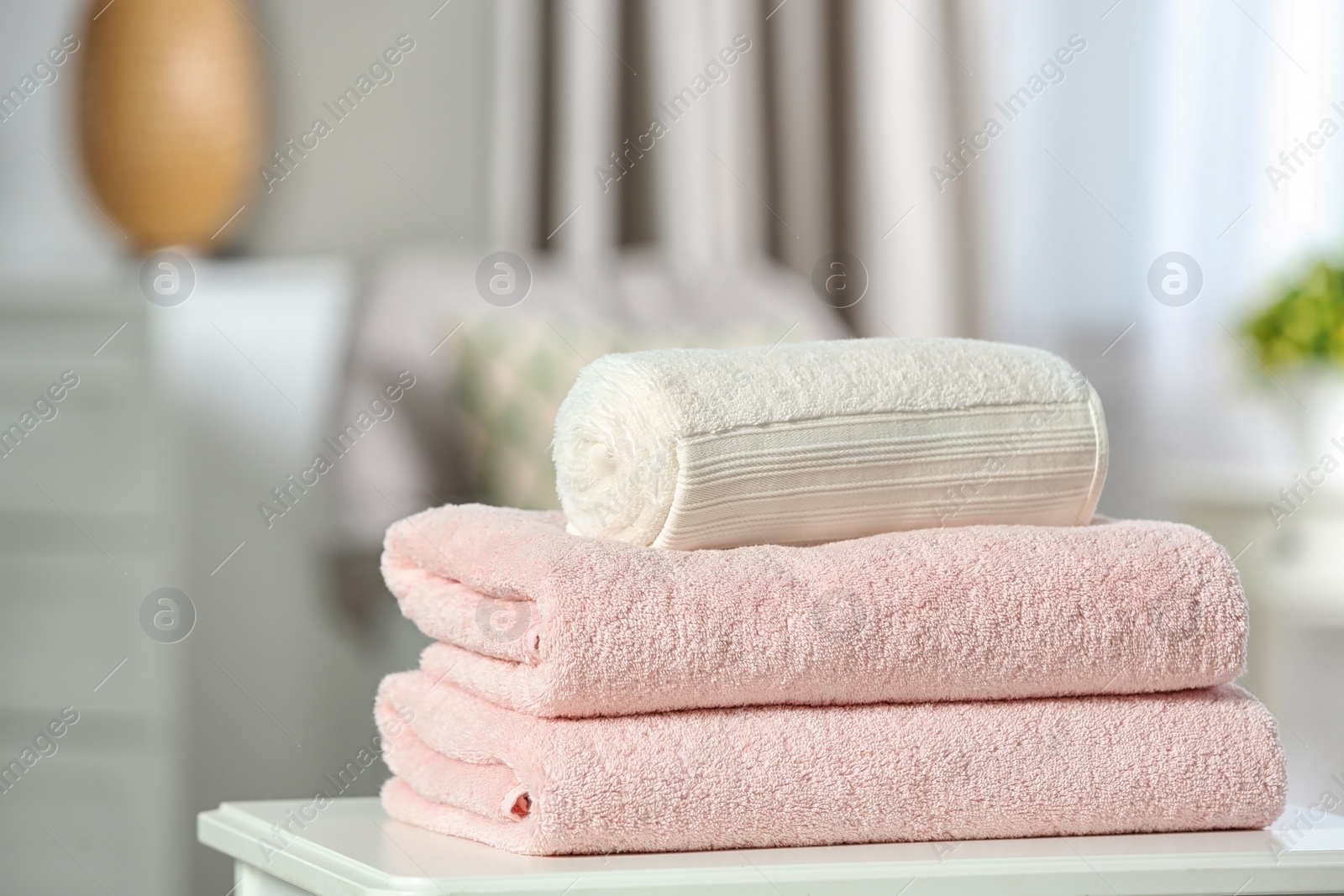 Photo of Clean soft terry towels on table indoors