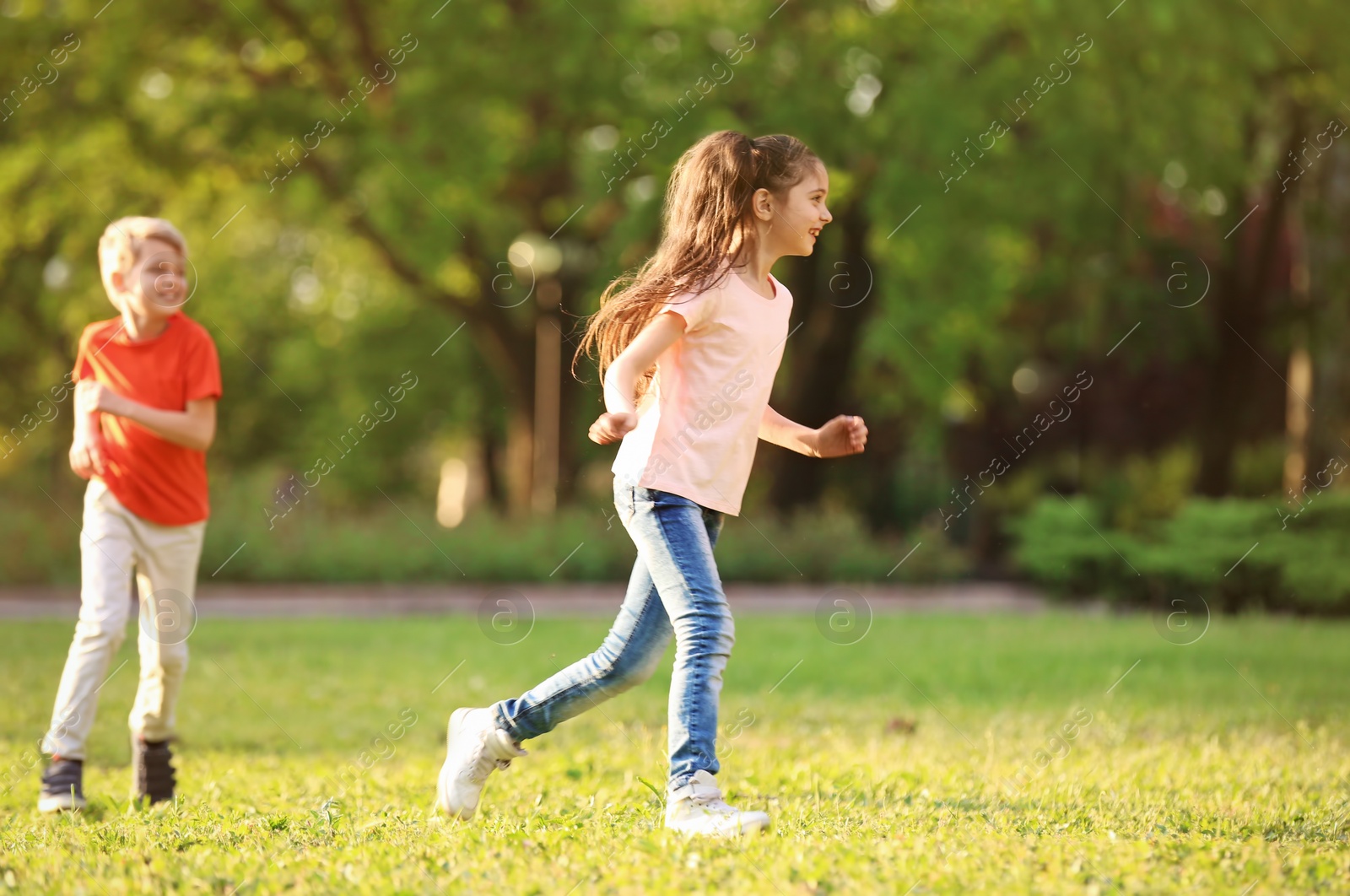 Photo of Cute little children playing together outdoors on sunny day