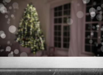 Empty stone surface and blurred view of room decorated for Christmas