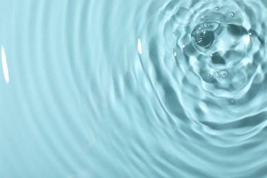 Photo of Closeup view of water with rippled surface on light blue background