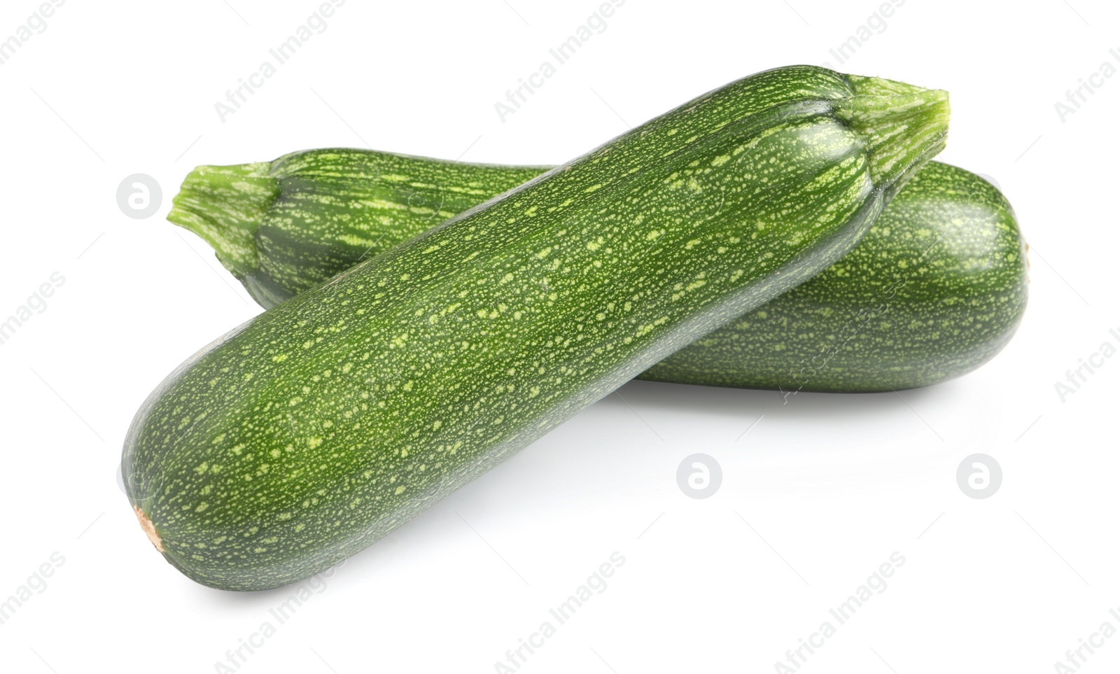 Photo of Fresh raw ripe zucchinis on white background