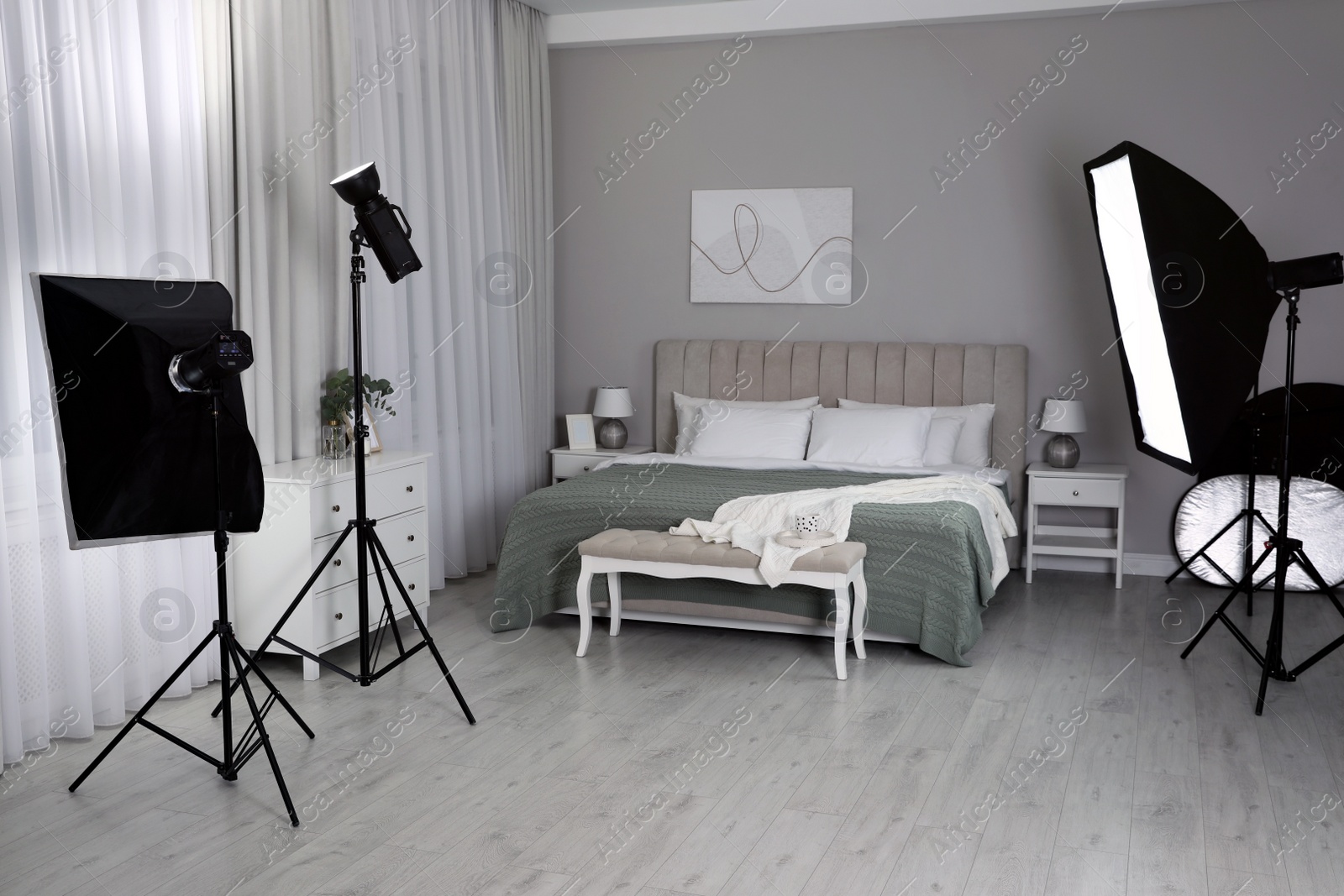 Photo of Professional photo studio equipment prepared for shooting bedroom interior