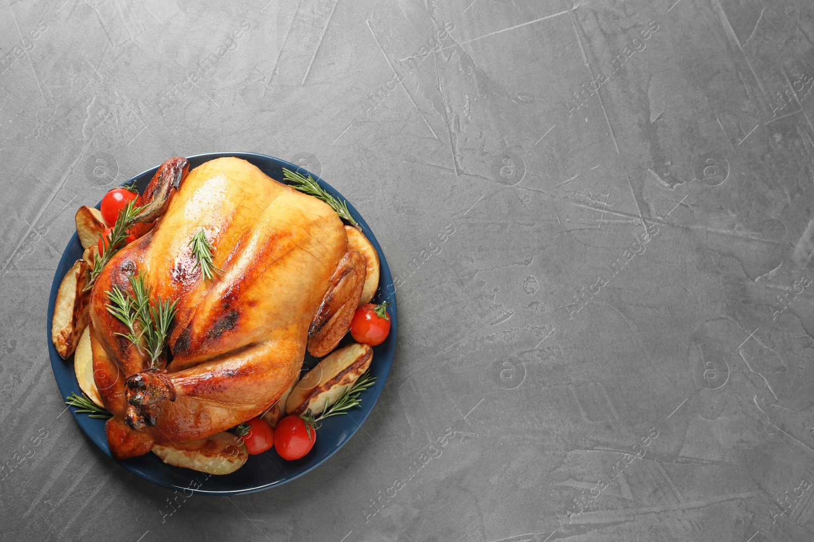Photo of Delicious roasted turkey on table, top view. Space for text