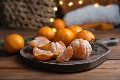 Tray with delicious ripe tangerines on wooden table