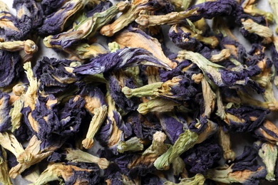 Dry organic blue Anchan as background, closeup. Herbal tea