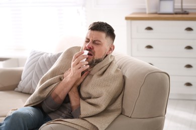 Photo of Man suffering from runny nose at home