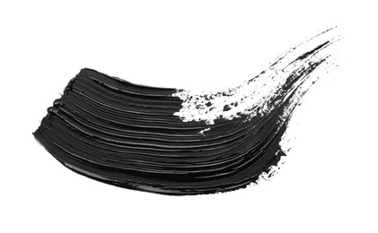 Photo of Brushstrokes of black oil paint on white background, top view