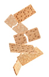 Fresh crunchy rye crispbreads falling on white background