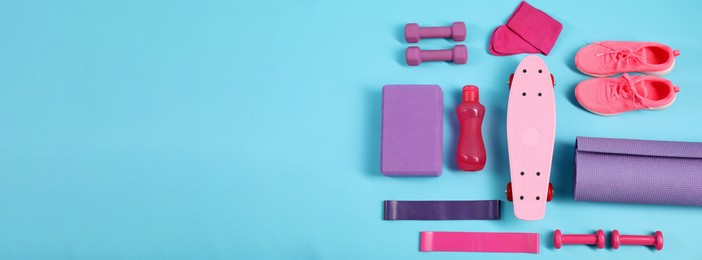 Different sports equipment on light blue background, flat lay