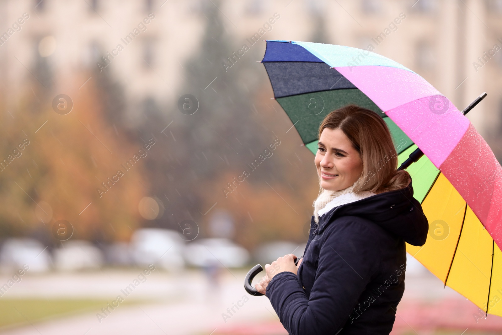 Photo of Woman with umbrella in city on autumn rainy day