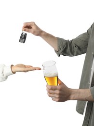 Man with glass of alcoholic drink giving car key to woman on white background, closeup. Don't drink and drive concept