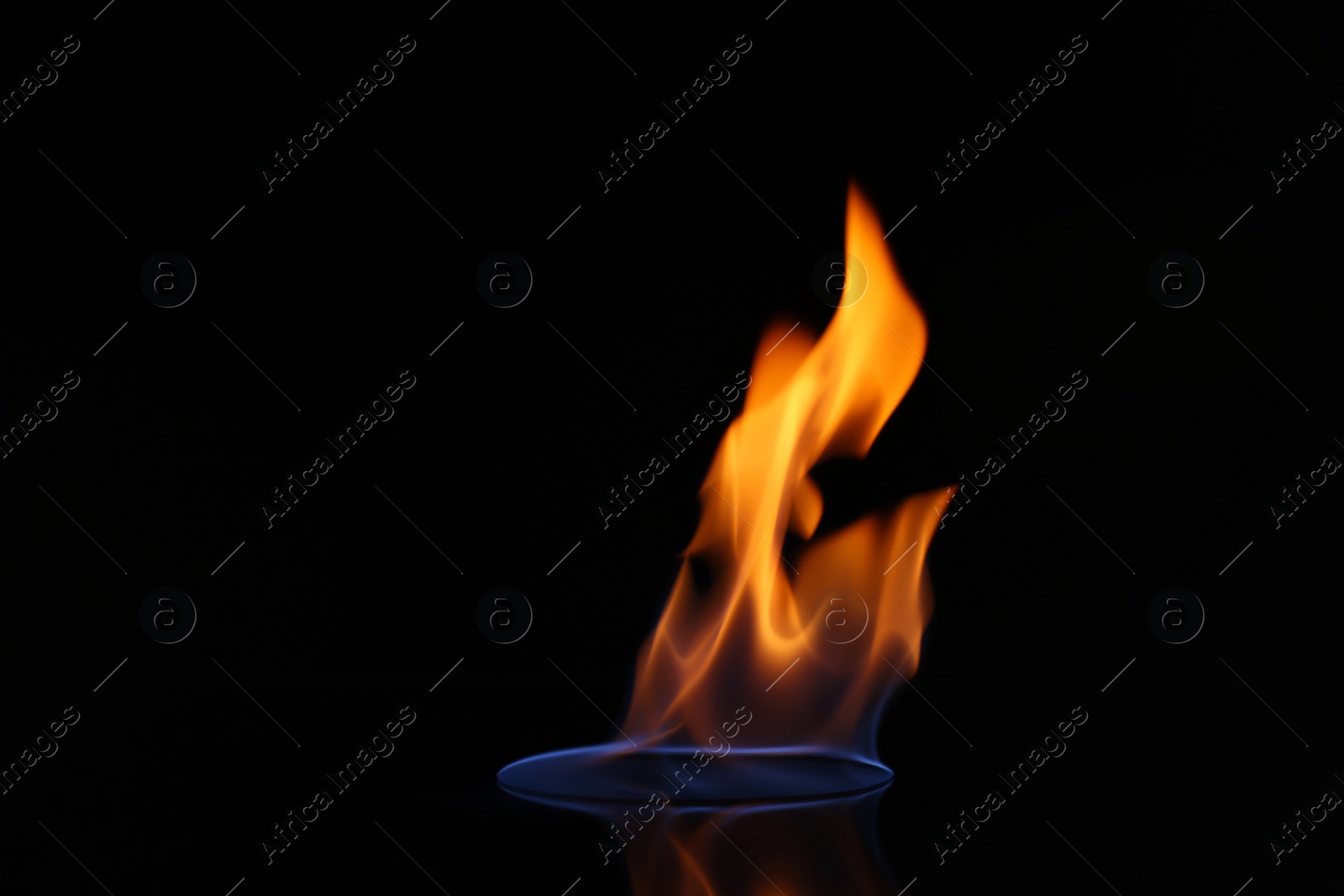 Photo of Beautiful view of flaming vodka on black background