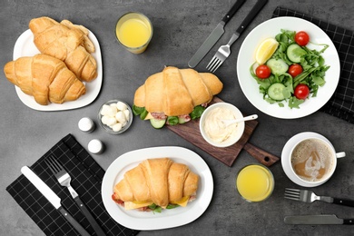 Photo of Tasty breakfast with fresh croissants on table, top view