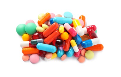 Pile of different colorful pills on white background, above view