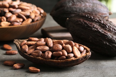 Photo of Cocoa pod of beans on grey table