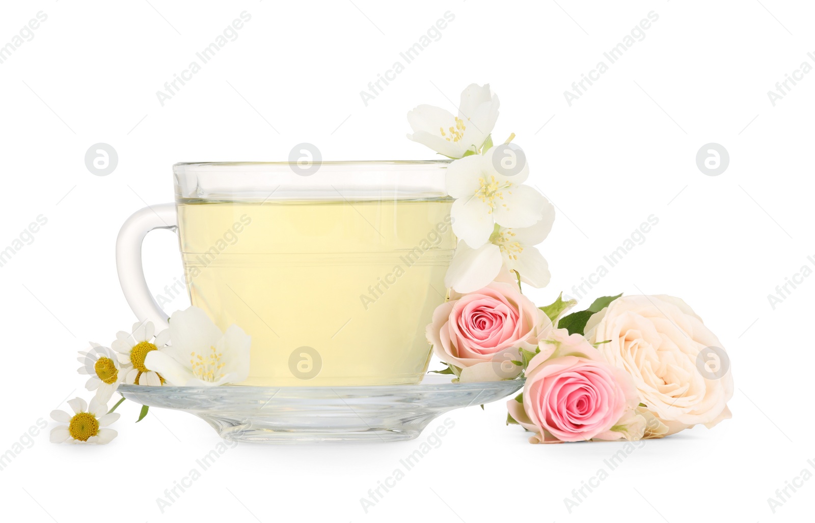 Photo of Aromatic herbal tea in glass cup and flowers isolated on white