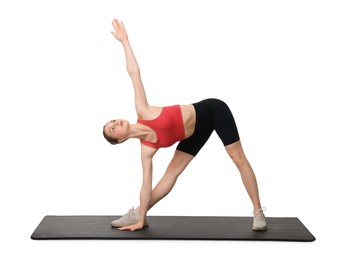Photo of Yoga workout. Young woman stretching on white background