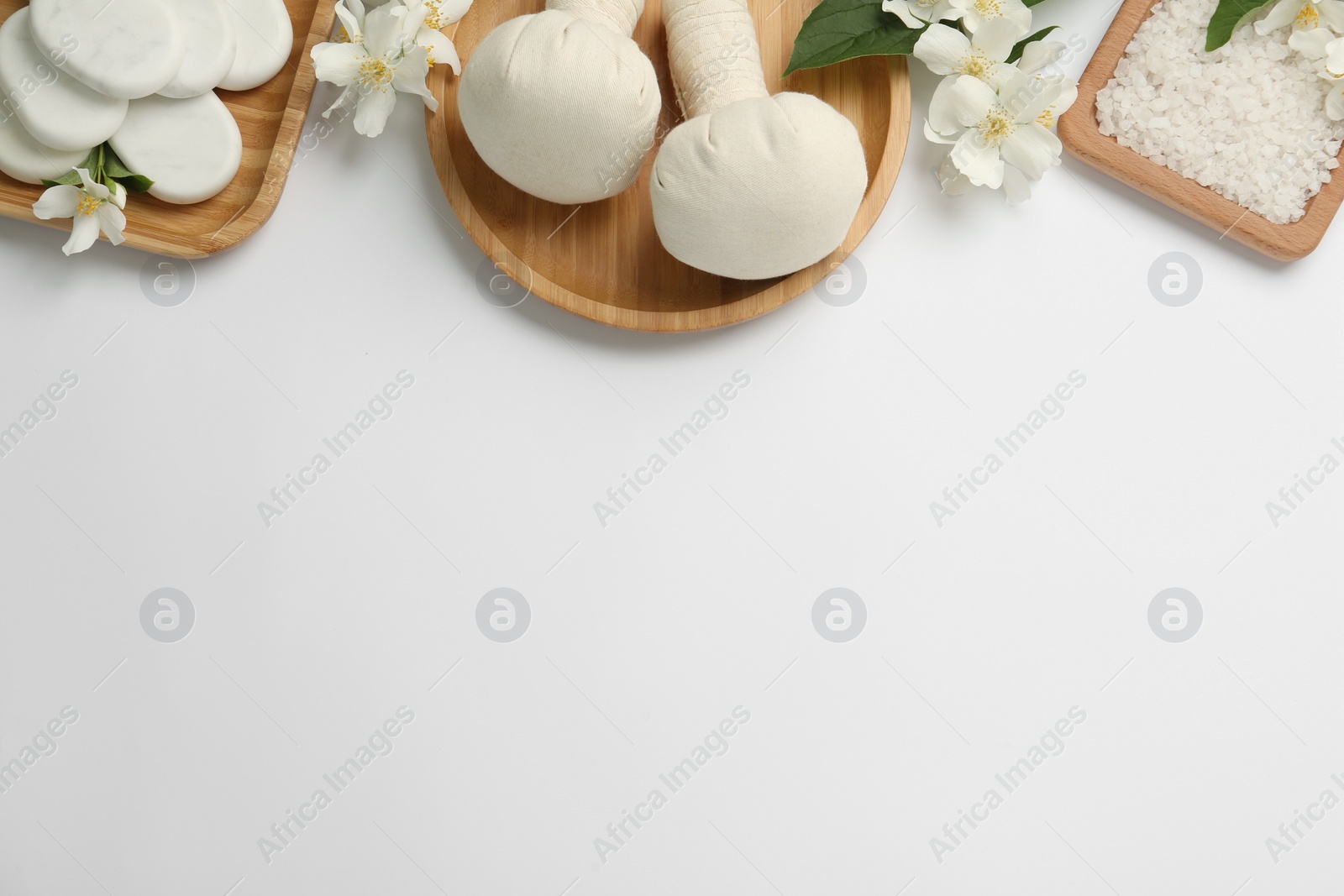 Photo of Flat lay composition with spa stones and beautiful jasmine flowers on white background, space for text