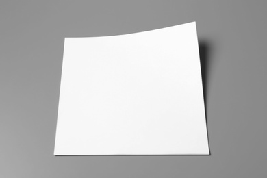 Photo of Blank paper sheets for brochure on grey background. Mock up