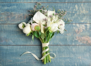 Photo of Bouquet of beautiful fragrant flowers on wooden background