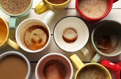 Photo of Many different cups with aromatic coffee and dirty ones on white wooden table, flat lay