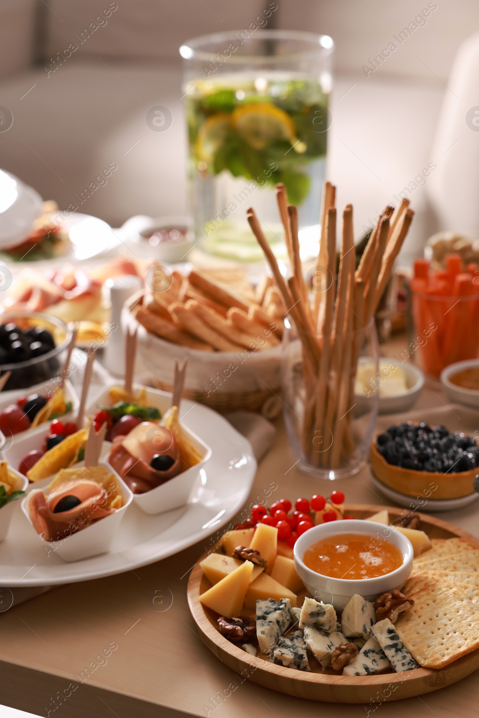 Photo of Dishes with different food on table in living room. Luxury brunch