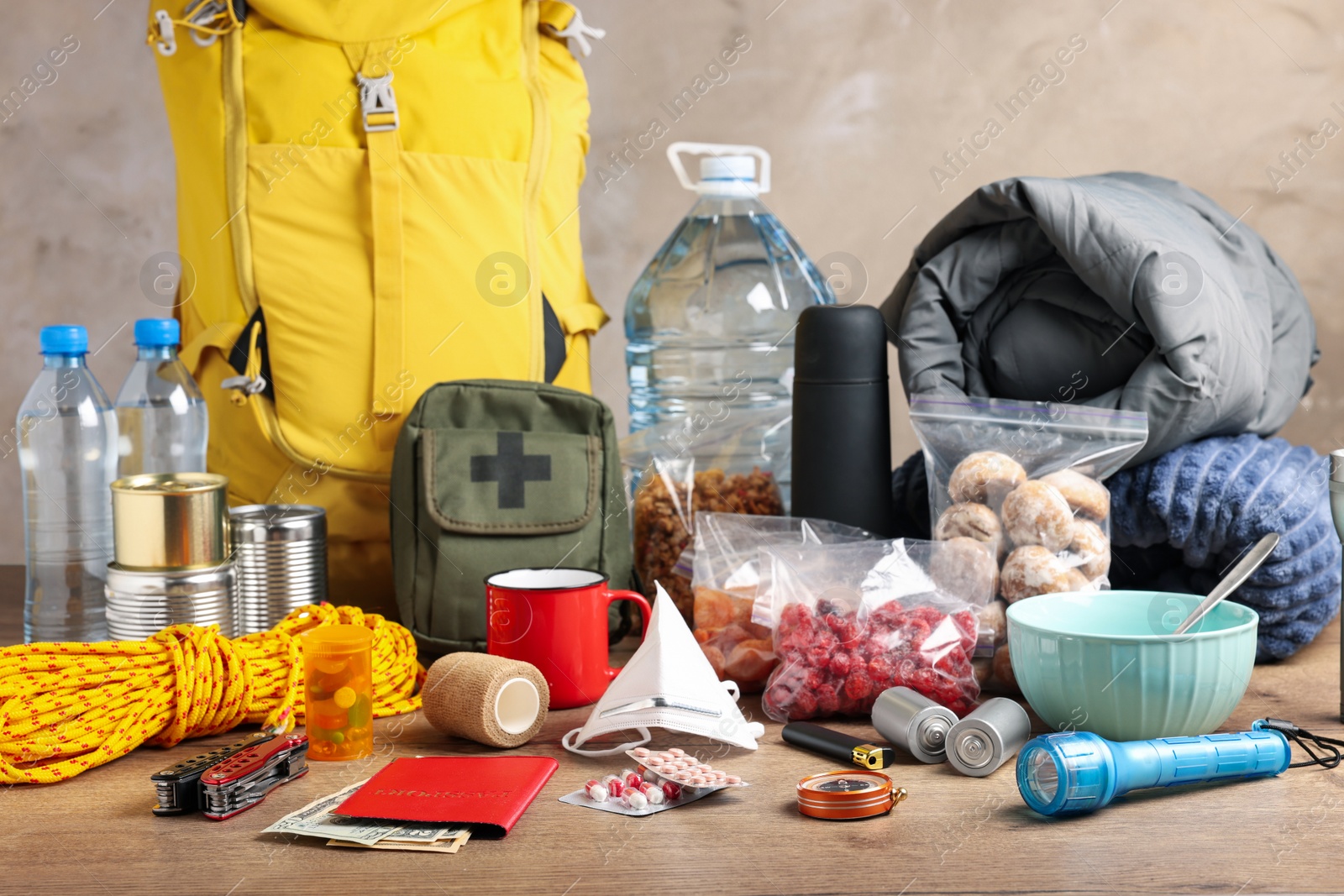 Photo of Disaster supply kit for earthquake on wooden table