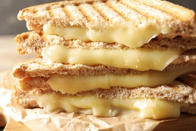 Tasty toast sandwiches with cheese on table, closeup