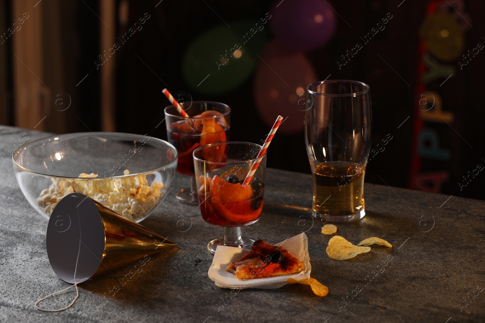 Photo of Messy table with drinks and food leftovers indoors. After party chaos