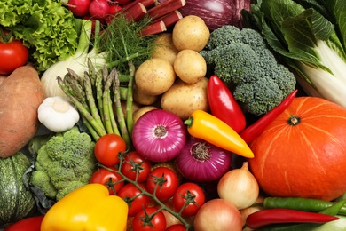 Photo of Different fresh vegetables as background, closeup view