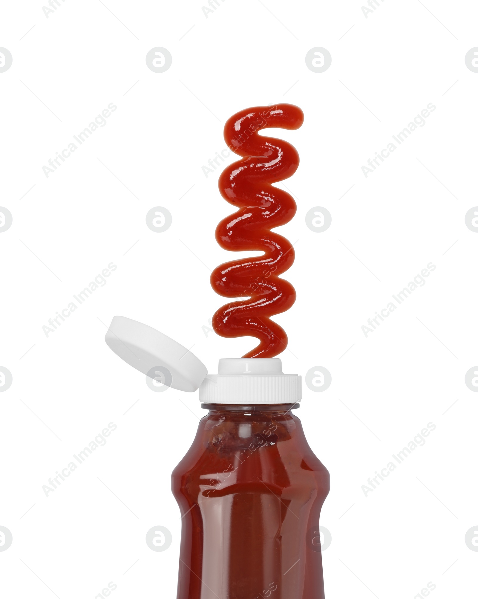 Photo of Squeezed ketchup from bottle isolated on white, top view