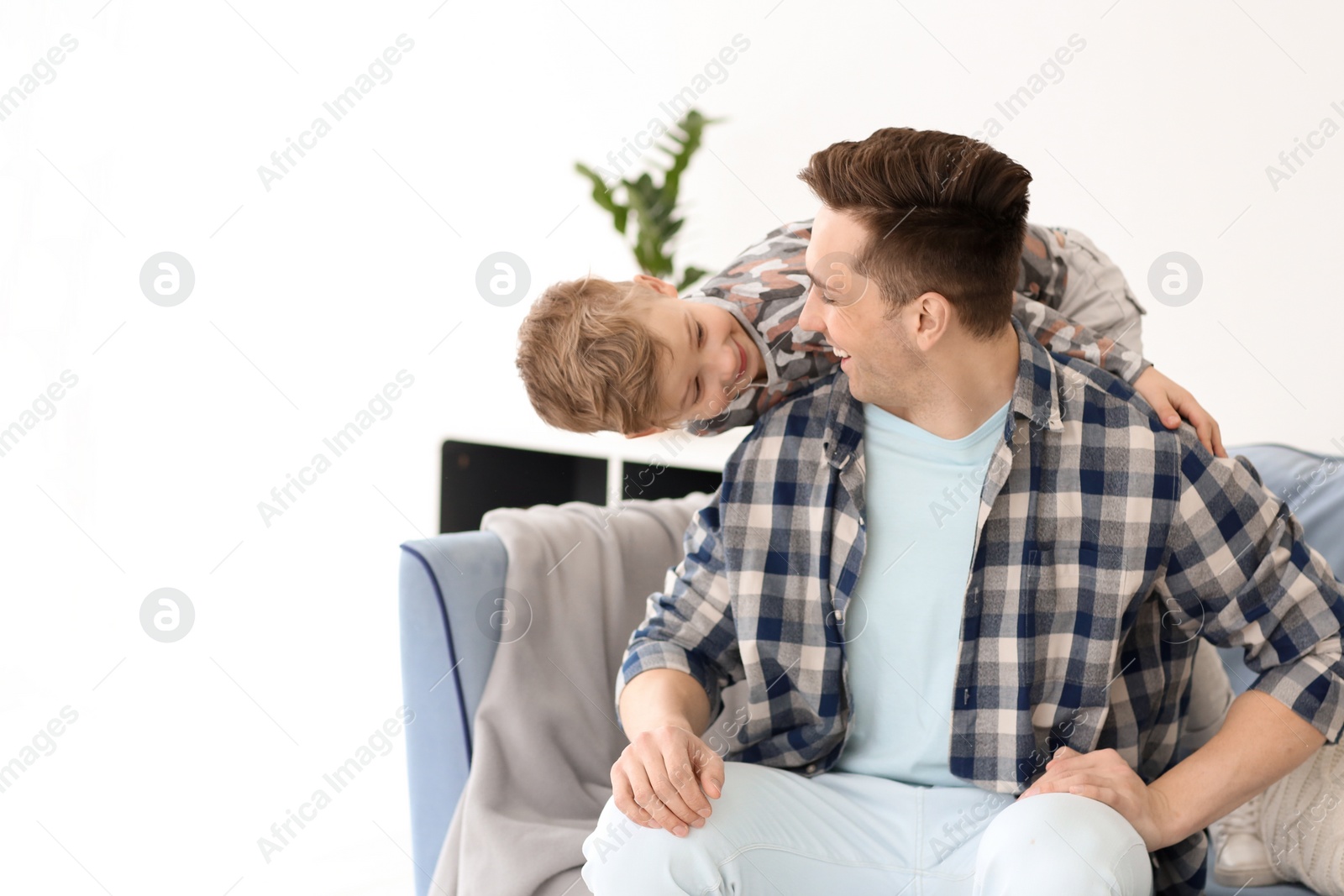 Photo of Dad and his son having fun at home