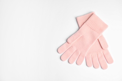 Photo of Stylish pink gloves on white background, top view with space for text. Autumn clothes