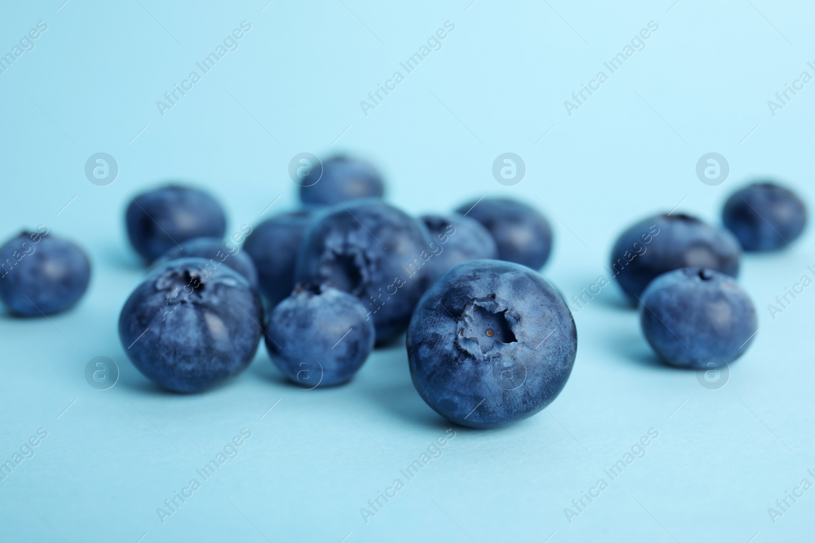 Photo of Tasty ripe blueberry on color background, closeup