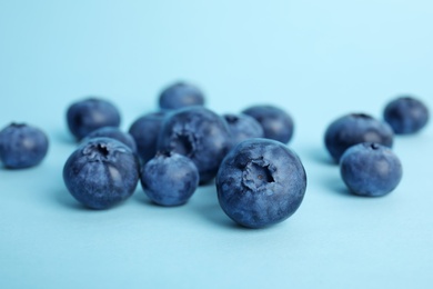 Tasty ripe blueberry on color background, closeup