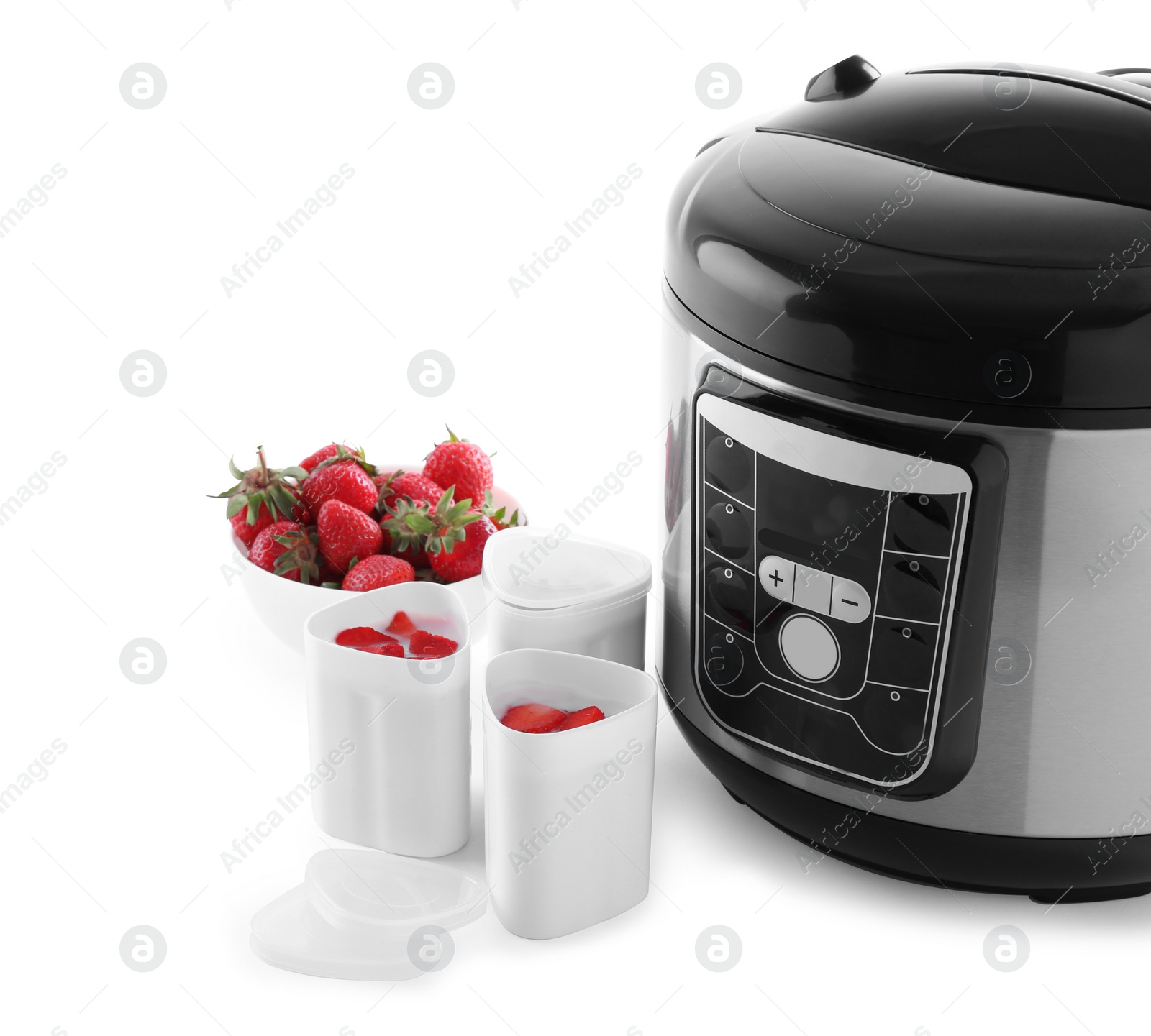 Photo of Modern multi cooker with cups of homemade yogurt and strawberries isolated on white