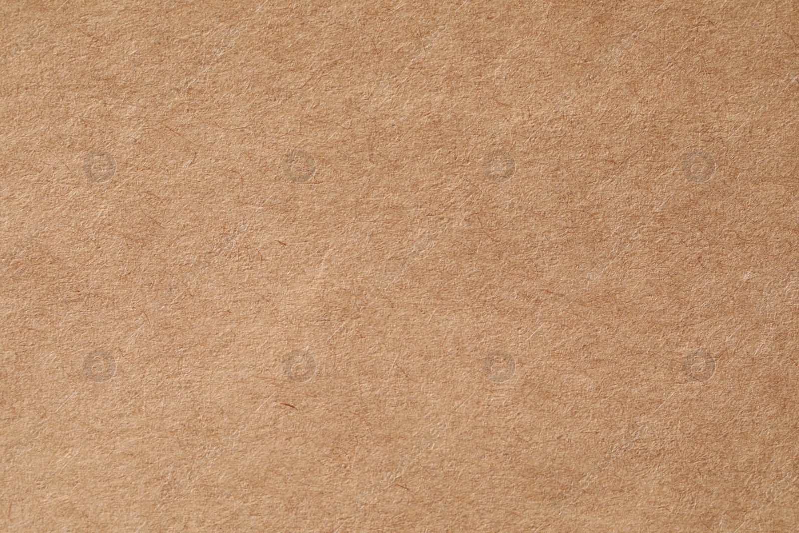 Photo of Texture of kraft paper sheet as background, closeup