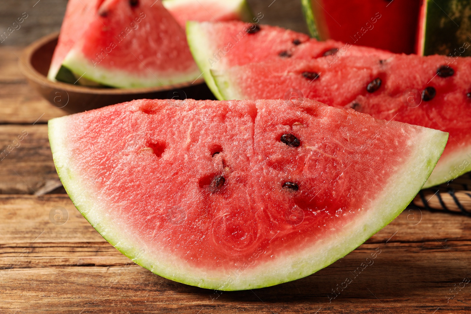 Photo of Delicious fresh watermelon slices on wooden table, closeup