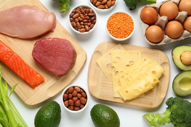 Photo of Different fresh products on white background, top view. Sources of essential amino acids