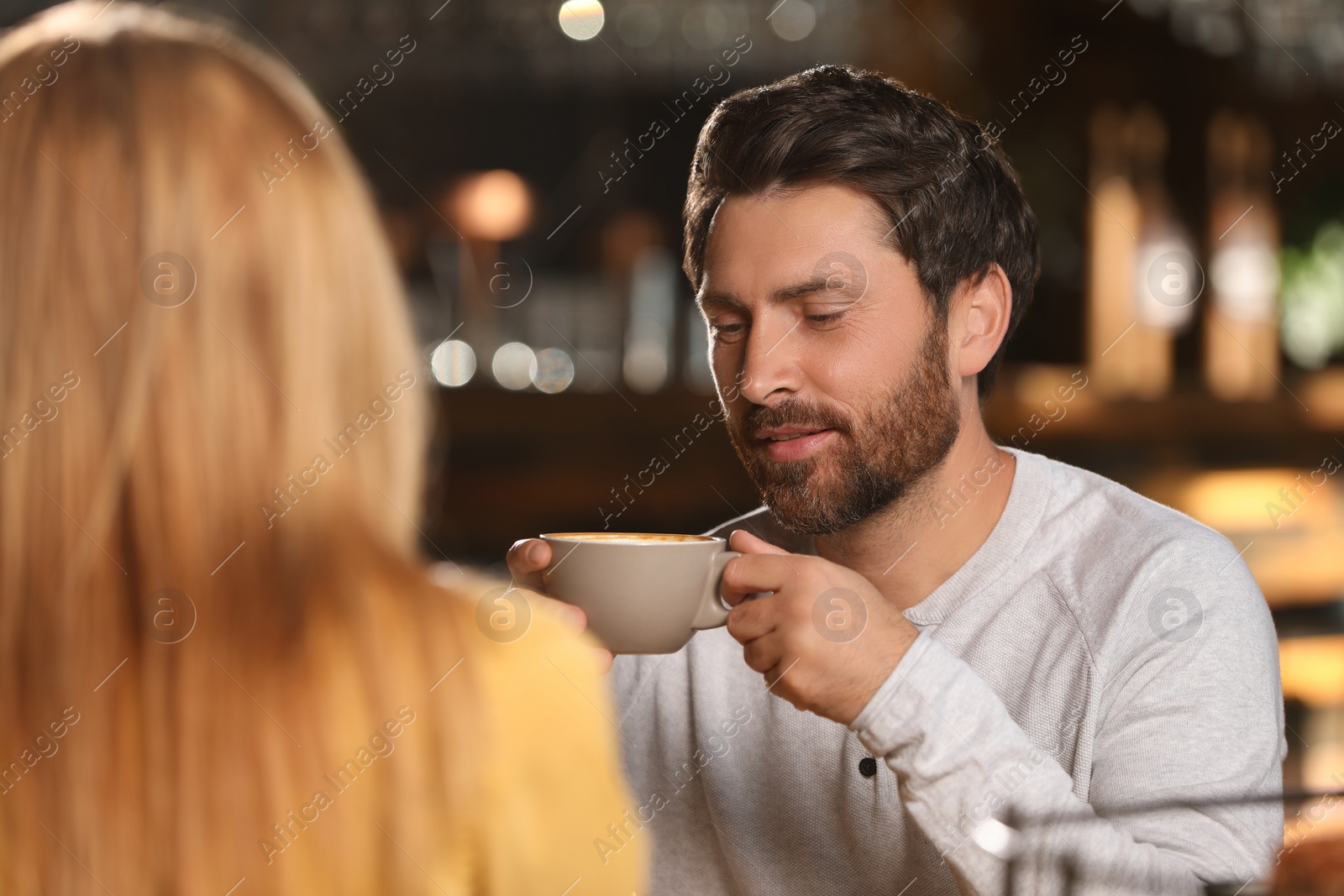 Photo of Romantic date. Lovely couple spending time together in cafe