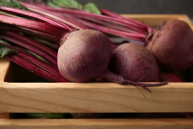 Wooden crate with fresh organic beets, closeup