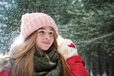 Portrait of teenage girl in winter snowy forest