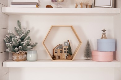 Photo of Wall shelves with beautiful Christmas decor indoors. Interior design