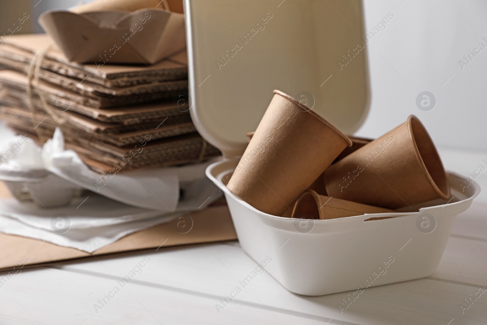 Photo of Heap of waste paper on white wooden table