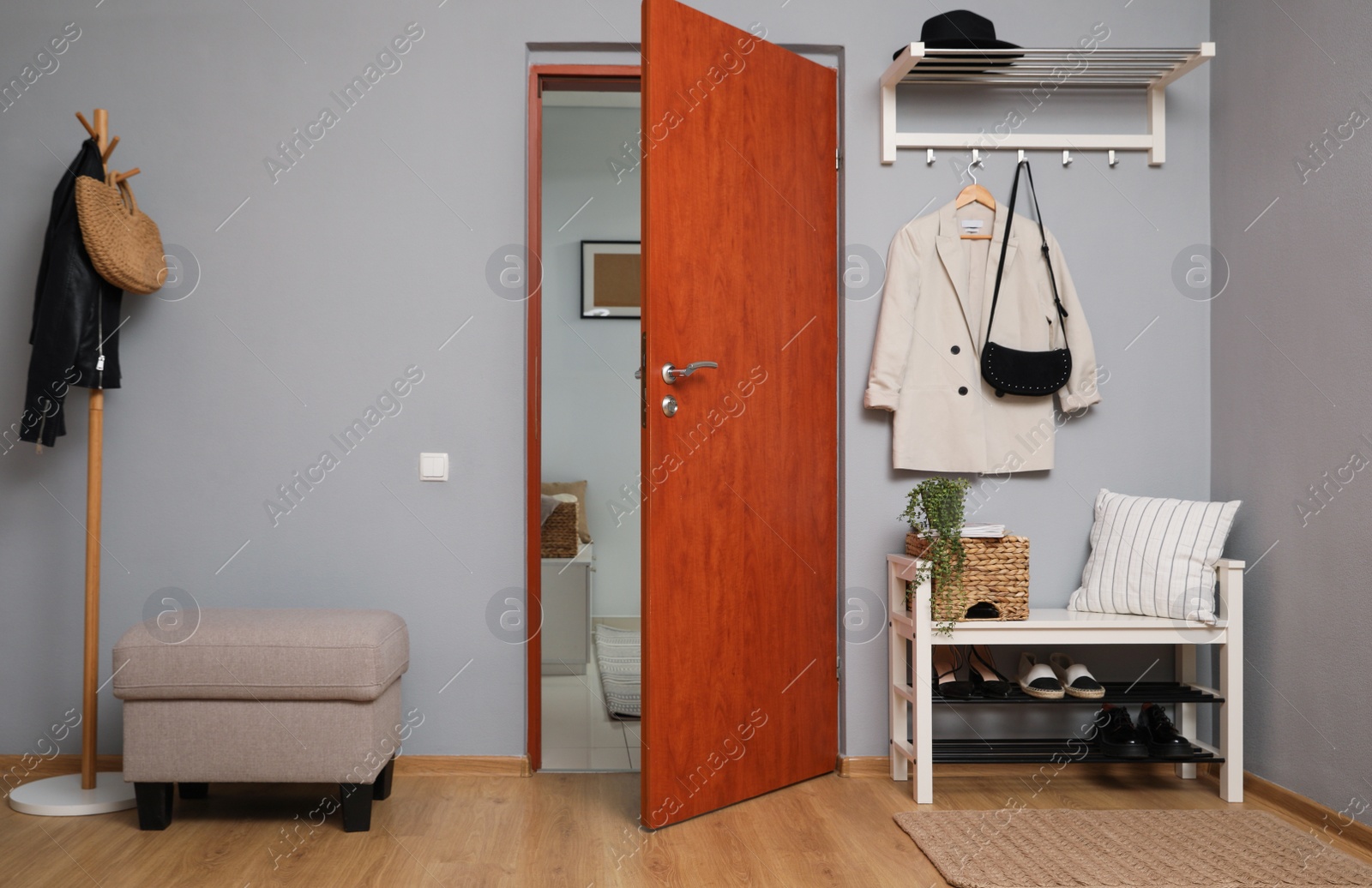 Photo of Modern hallway interior with shoe rack and wooden coat stand