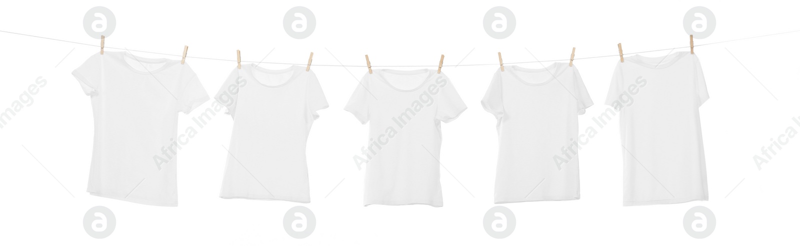 Photo of Many t-shirts drying on washing line isolated on white