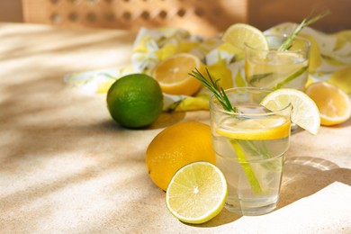 Tasty summer refreshing lemonade and ingredients on light table, space for text