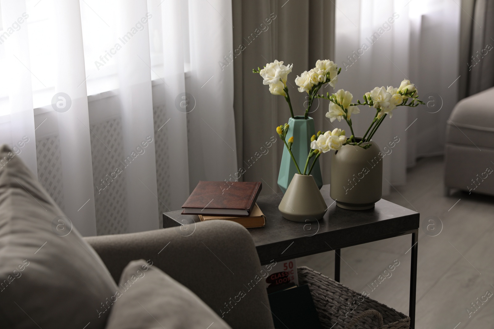 Photo of Beautiful spring freesia flowers on table in room