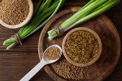 Photo of Tray with delicious whole grain mustard, seeds and fresh green onion on wooden table, flat lay