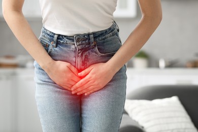 Image of Woman suffering from cystitis symptoms indoors, closeup